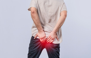 Man with diarrhea problem, man with digestive problem touching his buttock, man with hemorrhoid...