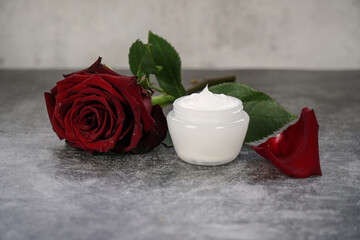Obraz na płótnie Canvas Skincare beauty treatment plant-based products with red rose petals. Jar of body or face moisturizer, homemade cosmetic ingredients. 