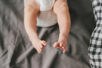 Close up of newborn feet. Soft focus. Grey and white colors.
