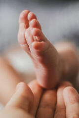 Close up of newborn baby's foot. Extreme Close Up Of Hand Holding Baby Foot.
