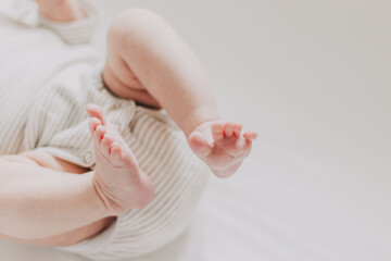 Close up of newborn feet. Soft focus. Beige palette.