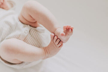 Close up of newborn feet. Soft focus. Beige palette.