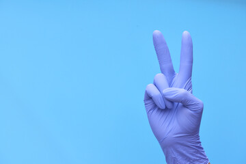 a hand in medical blue gloves shows a countdown of time or the number of drugs