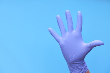 a hand in medical blue gloves shows a countdown of time or the number of drugs