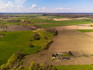 Obraz premium Spring fields, meadows and villages seen from a bird's eye view on a sunny, clear day. Spring.
