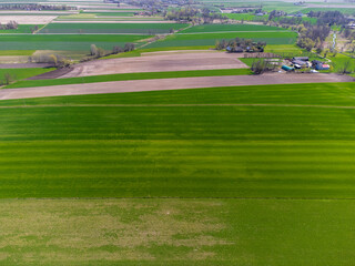 Spring fields, meadows and villages seen from a bird's eye view on a sunny, clear day. Spring.
