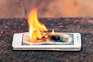 Mobile phone, smartphone, on fire. Burning smartphone