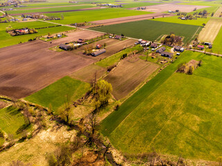 Obraz premium Spring fields, meadows and villages seen from a bird's eye view on a sunny, clear day. Spring.