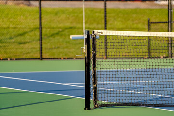 Image of a new tennis court with net and post