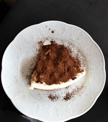 Tiramisu cake dessert on white plate, tiramisu is dessert, top view