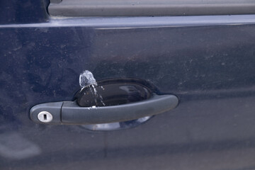 The bird pooped on the handle of the car. Bird shit, dirty waste of birds dropping splatter....