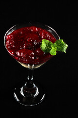 red fruit dessert, raspberry sauce, strawberry with cream and jam served in a glass bowl