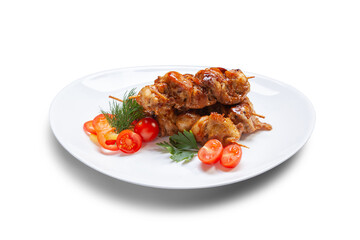 Japanese cuisine yakitori chicken served on a white plate with tomatoes and greens, close-up, isolate. Delicious chicken satay on skewers.