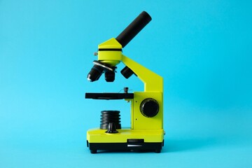 Microscope on a bright blue background. High quality photo.