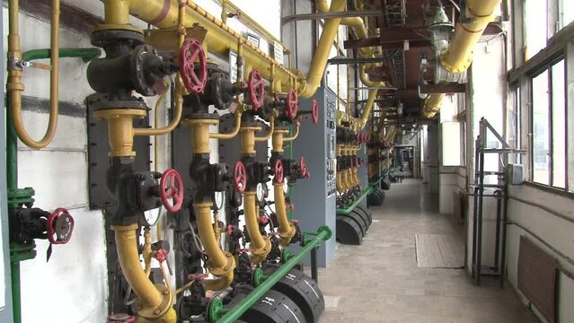 Boiler room with pipes, valves and sensors.Manometer, pipes and faucet valves of heating system in a boiler room.