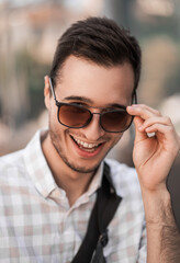 focus on details. portrait of a young handsome man in sunglasses