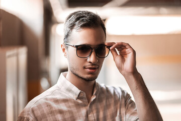 portrait of a young handsome man in glasses and shirt