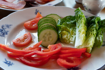 Healthy vegetarian vegetable salad of fresh lettuce, cucumber, sweet pepper and tomatoes.