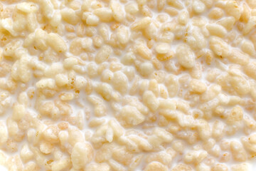 Crispy rice cereal with milk texture background.