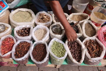 Vendor selling different types of spices at a market