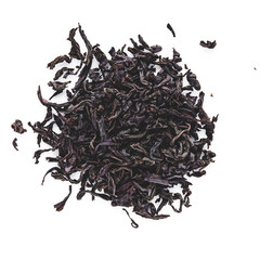 dried black tea on a white acrylic background