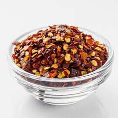 spicy chili flakes on a white background