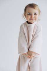 29.04.22 Kyiv, Ukraine: little stylish girl of one and a half years poses for a photo on a white studio cyclorama