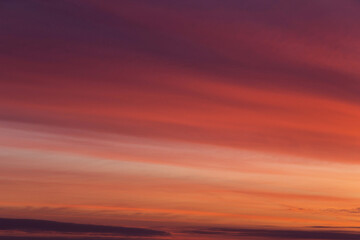 Beautiful soft sunrise, sunset yellow orange red striped sky with cirrus clouds abstract background texture