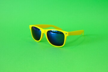 Sunglasses on a green background. High quality photo
