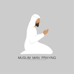 Muslim man in white clothes prays with arms raised.