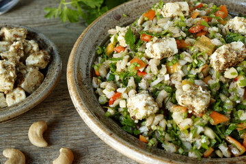 Barley and parsley salad with feta and cashew nuts. Middle Eastern cuisine food.