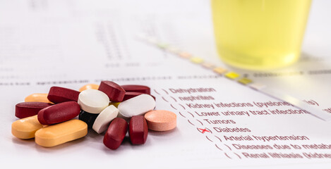 urine test accusing diabetes, with urine bottles in the background and reagent strip, pills for...