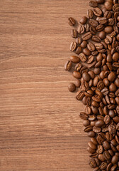 Roasted coffee beans background. Coffee background on the wood. Top view