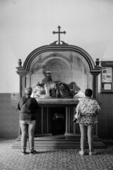 two women praying to an image of Jesus

