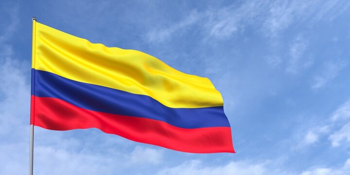 Colombia flag on flagpole on blue sky background. Colombian flag waving in the wind on a background of sky with clouds. Place for text. 3d illustration.