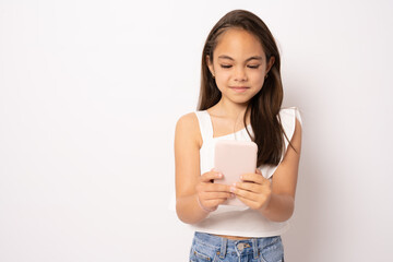 Cute beautiful little girl using smartphone on white background