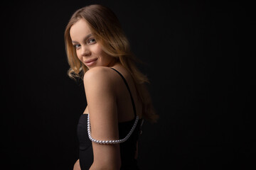 Fototapeta premium portrait on black background of young beautiful woman with makeup 