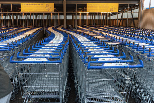 Falkenberg, Sweden - February 19 2022: Long rows of parked shopping trolleys at Gek?s Ullared.