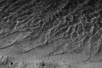Black and White shoreline of tropical beach on a bright, sunny vacation day