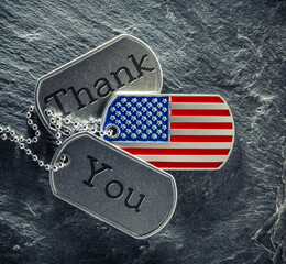 US military soldier's dog tags engraved with Thank You text and in the shape of the American flag. Memorial Day or Veterans Day concept. - obrazy, fototapety, plakaty