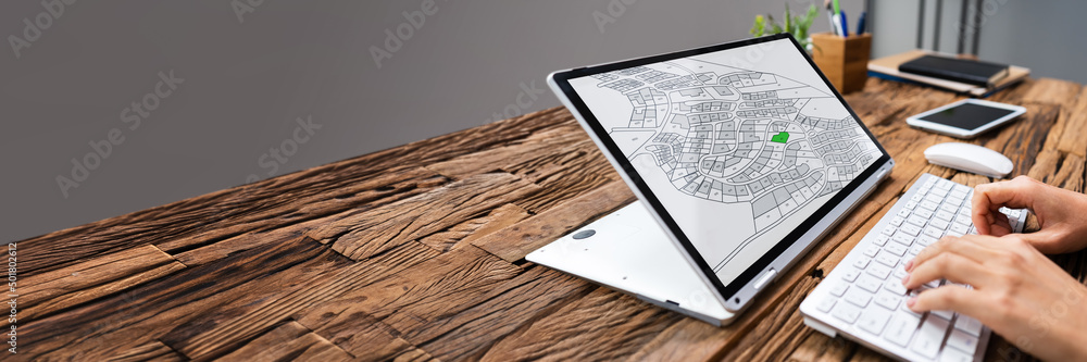 Poster businessperson analyzing cadastre map on computer