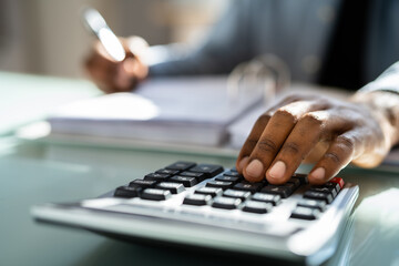 African American Male Accountant Using Calculator