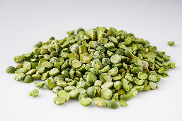dried green peas on a white acrylic background