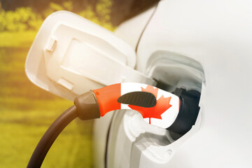 Charging an electric vehicle using an electric cable with a picture of the flag of Canada