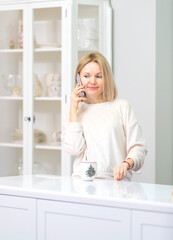 Young beautiful blonde girl at home in the kitchen