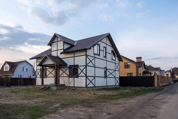 End of construction. The house is built on a plot surrounded by other houses. Houses in different styles