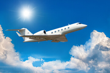 White modern luxury private jet flies in the air above the clouds - obrazy, fototapety, plakaty