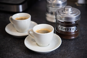 two cups of black coffee on the kitchen table