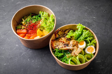 delicious poke bowl with fresh vegetables and seafood on a black background