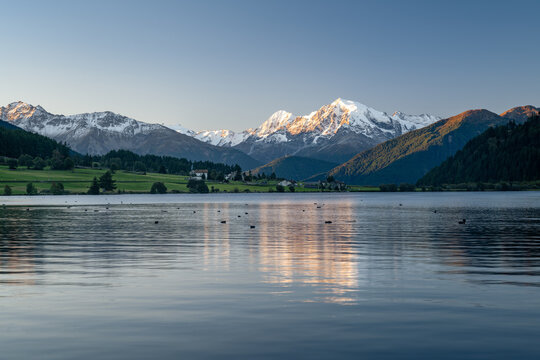 Mountain landscape in the morning light, Ortler reflected in Haidersee, Reschenpass, South Tyrol, Italy, Europe